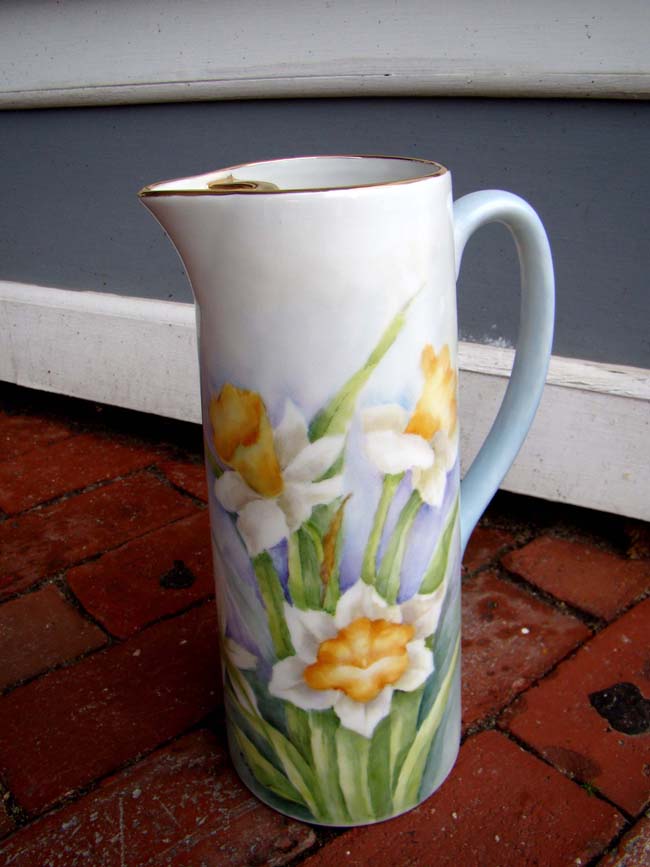 A beautiful early 20th century hand painted pitcher with yellow daffodils